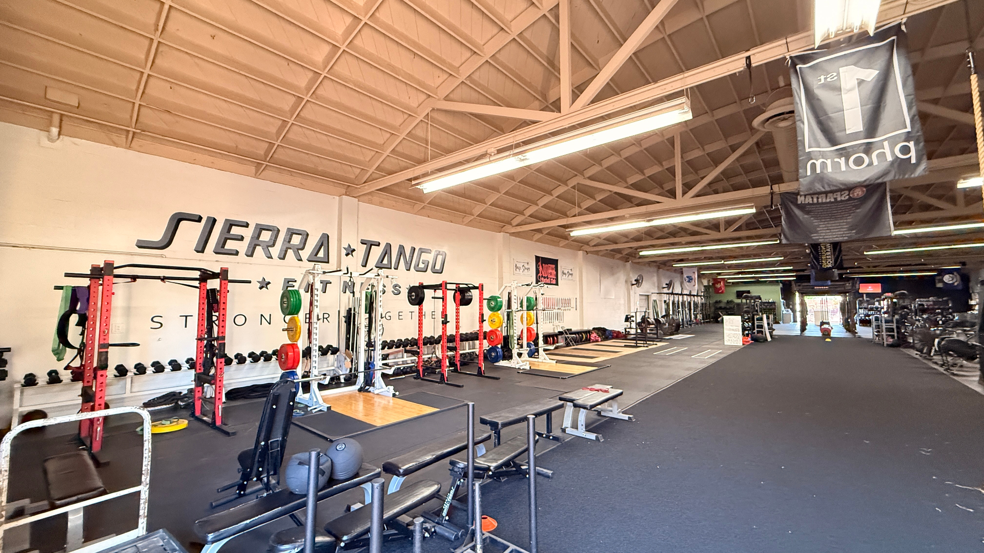 Sierra Tango Fitness strength training area with squat racks and free weights